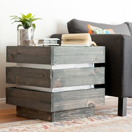This DIY three tier end table is the perfect addition to any living space. It is chunky and rustic with a modern metallic touch.
