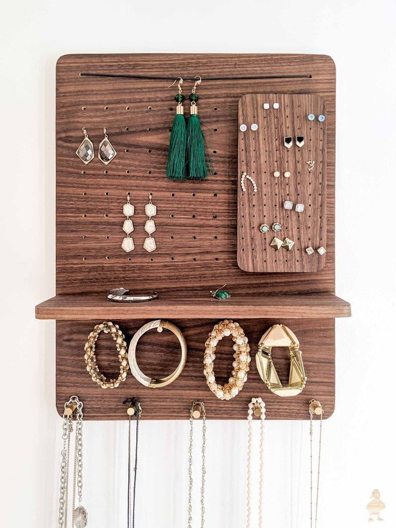 Wood wall hanging jewelry organizer with shelf with necklaces, earrings and bracelets