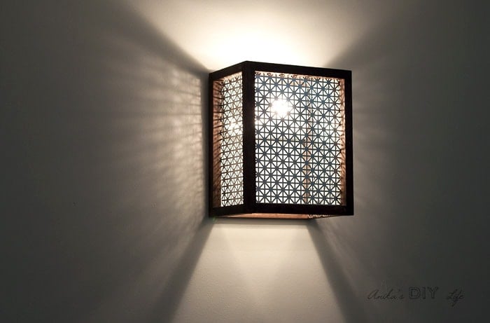 DIY wood light sconce with light turned on. How to make a light sconce