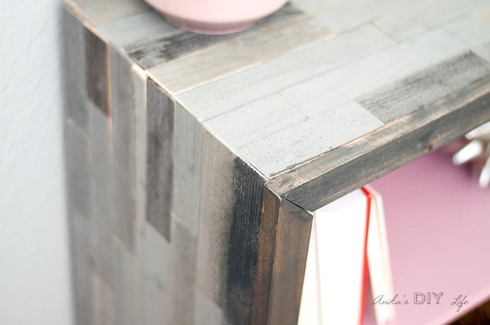 close up of corner of weathered barn wood wood bookshelf