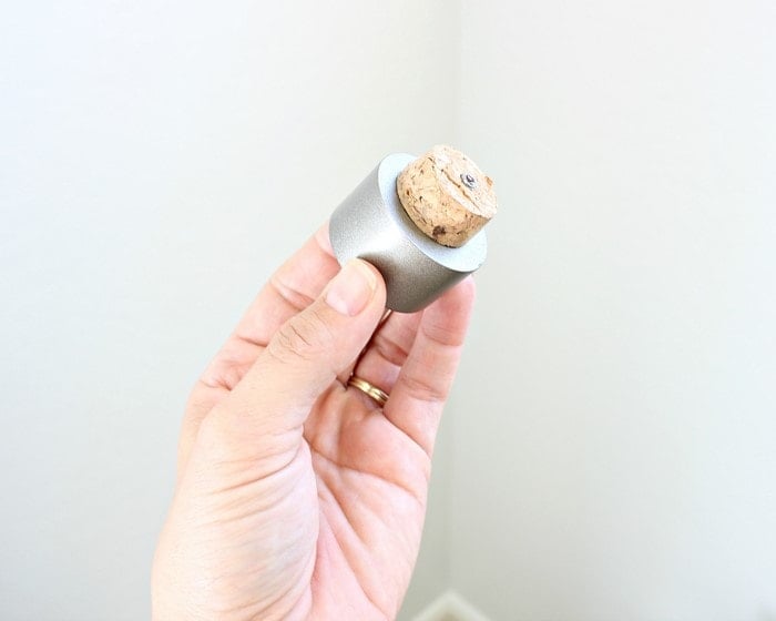 Champagne screwed on to a finial for a DIY curtain rod
