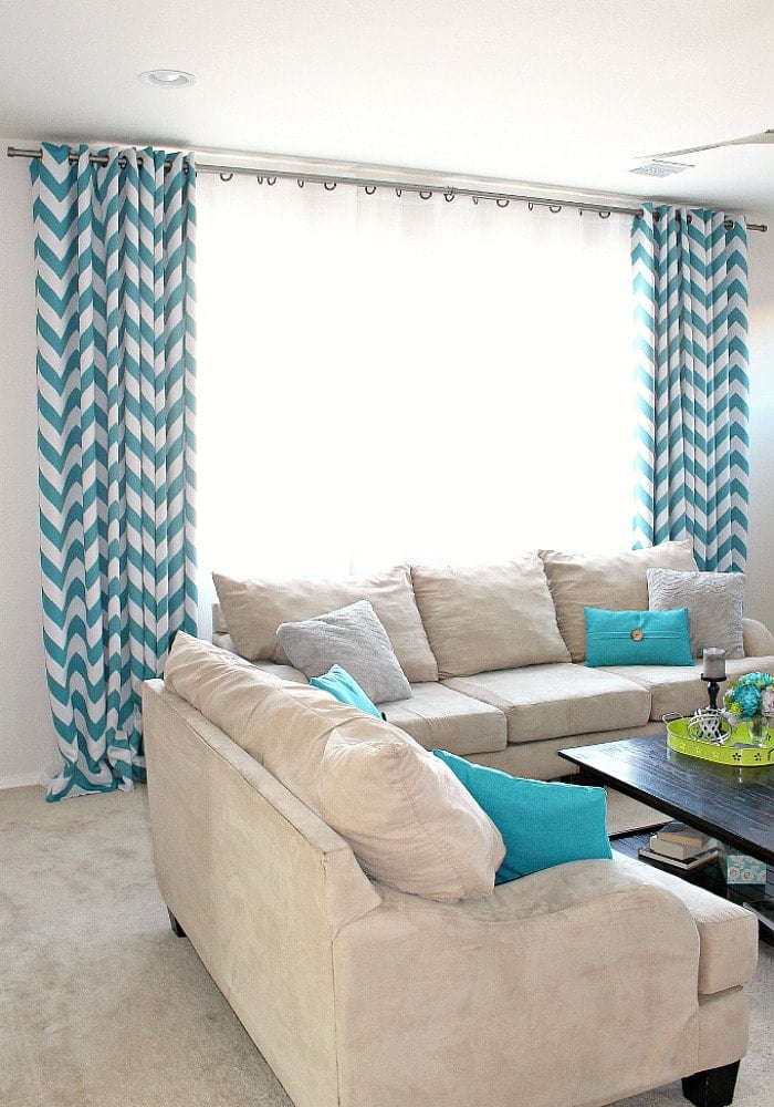 DIY curtain rods using electrical conduits in living room.