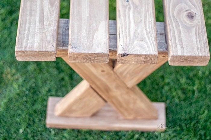 Close up of DIY 2x4 bench used indoors in an entryway.