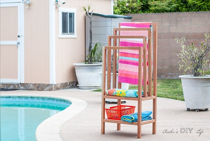 DIY freestanding towel rack in backyard next to pool
