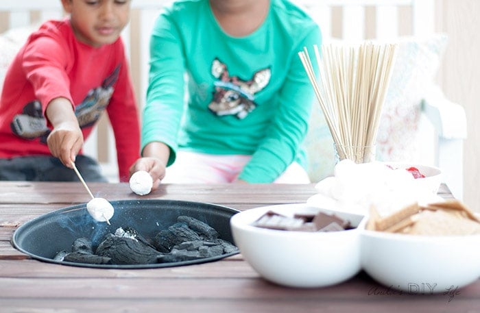Roasting marshmallows on the DIY patio table with fire pit. Review of ElectroLight Fire starter