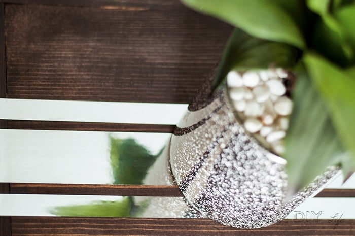 DIY sofa table with mirror tape and plant on top.