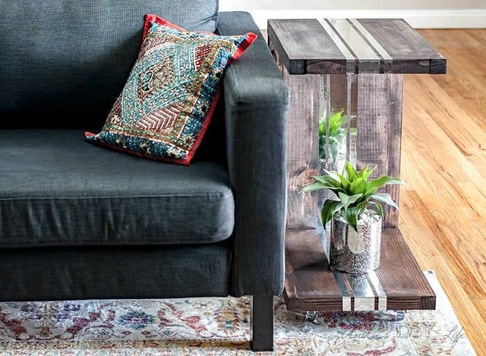 DIY sofa table next to couch with plant on the bottom