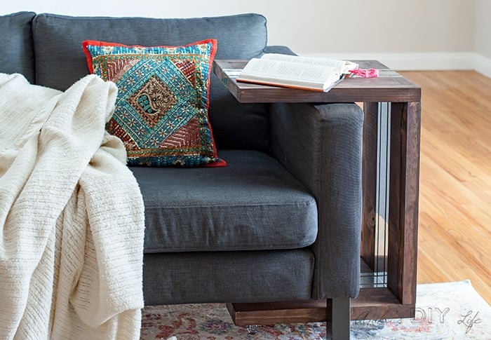 DIY sofa table next to a couch. Easy C-table with book on top.