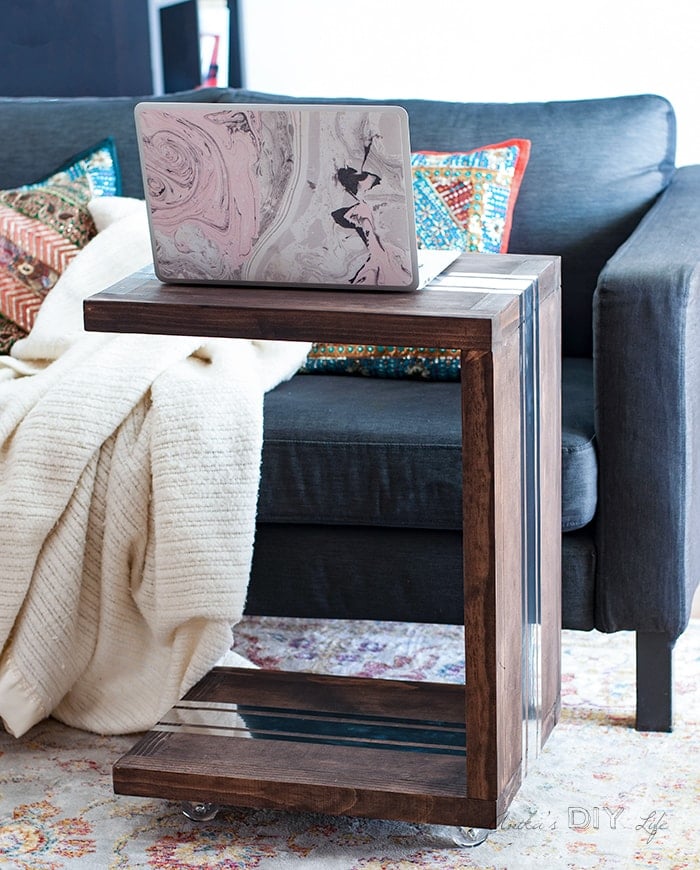 DIY sofa table in front of the couch with laptop on top.