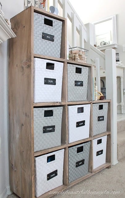 Under the stairs storage case built from wood and with bins