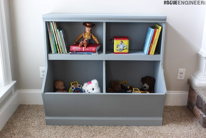 Toy storage with books and a bin for toys.