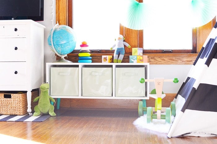 DIY toy storage bench with toys around it.