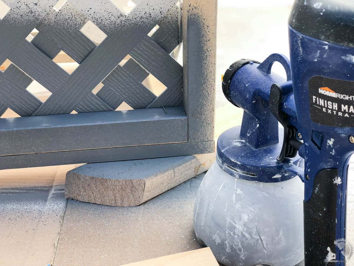using paint sprayer to apply paint to the planter