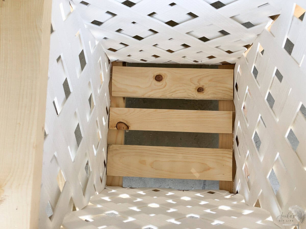 adding planks on the inside of the planter.