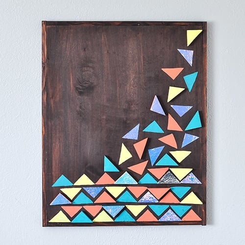 How to make an easy DIY wood wall art using few pieces of scrap wood. Full step by step tutorial and video to make the large-scale colorful geometric wall art.