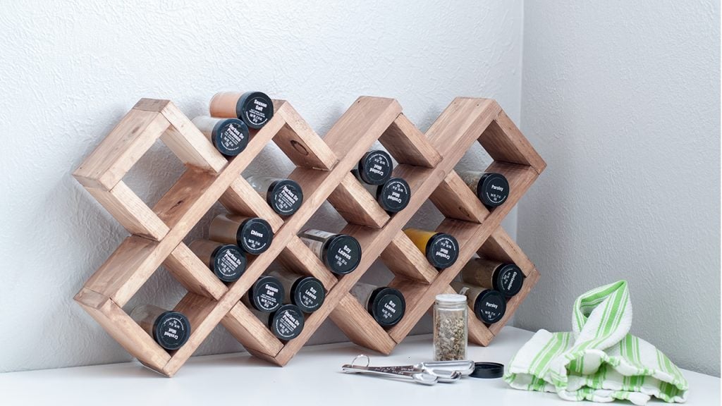 DIY spice rack on white countertop with text overlay