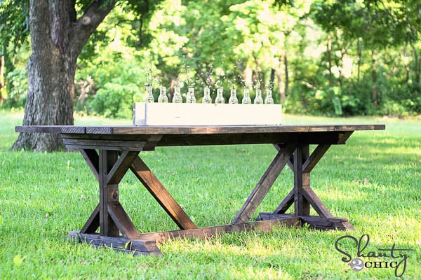 X-base dining table in grass