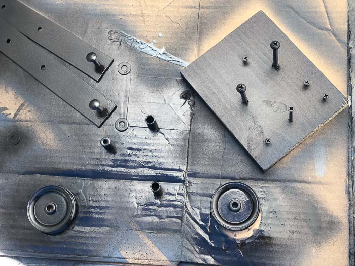 Painting DIY barn door hardware.