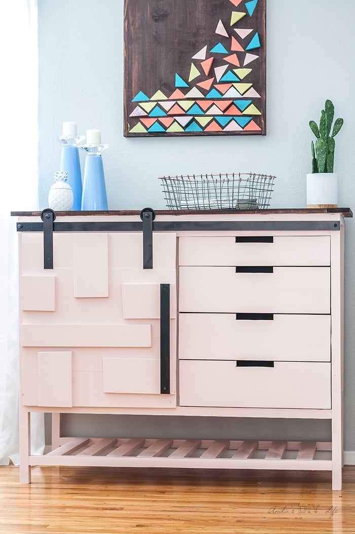 DIY Sliding Barn Door cabinet painted pink with stained top
