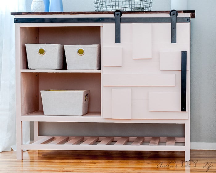 DIY sliding barn door cabinet with door open to show shelves.