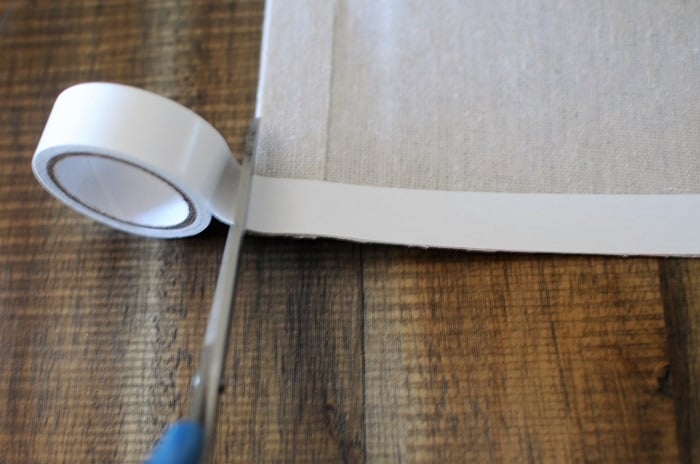 Attaching hem tape to make no-sew drop cloth curtains