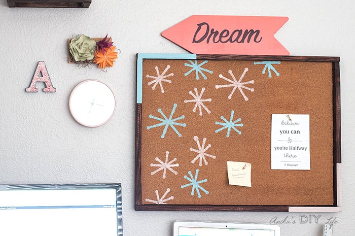 DIY cork bulletin board on gallery wall of creative office