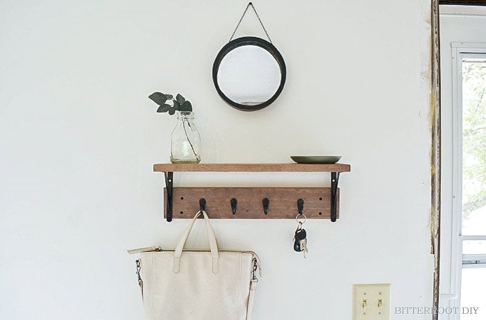 DIY entryway shelf with hooks underneath on wall