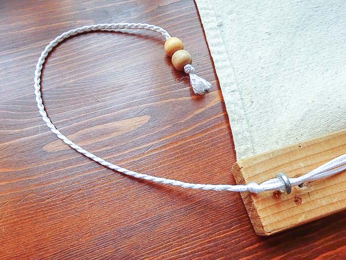 braided pull cord of DIY roman shade using drop cloth