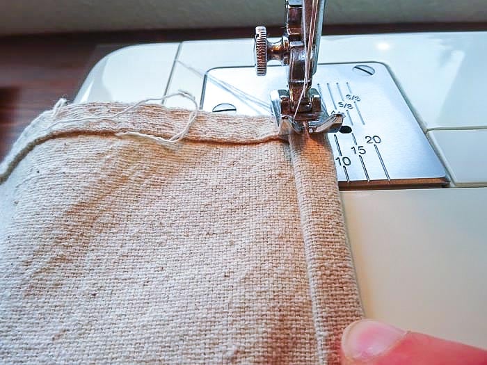 Hemming the drop cloth to make roman shades