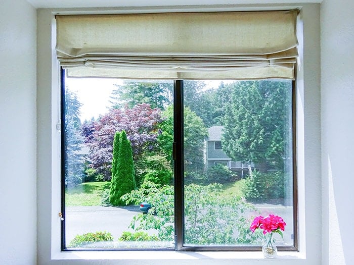 Window with drop cloth Roman shade
