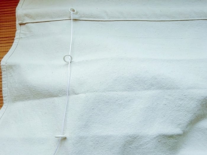 running drapery cord to make the DIY drop cloth roman shade