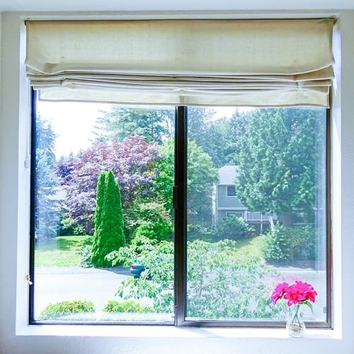 DIY Roman shades are a super inexpensive way to make your own stylish window coverings and create privacy.  This tutorial walks you through exactly how to make this using drop cloth!! 