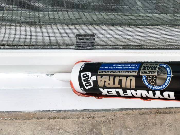 Sealing a window using DAP caulking. 