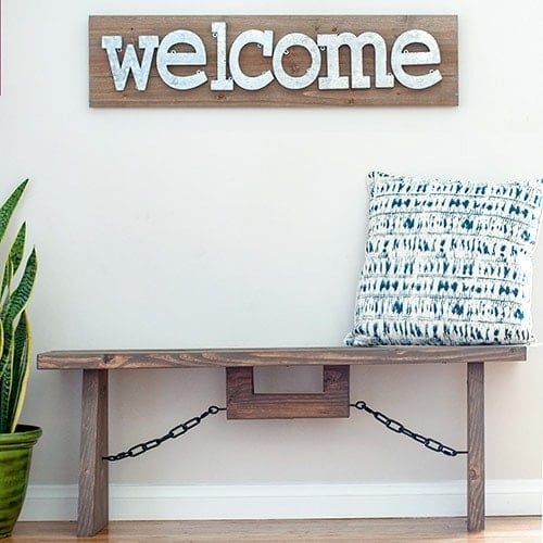 Build this easy DIY industrial farmhouse bench with structural lumber with these full tutorial and plans. Perfect for indoor or outdoors!