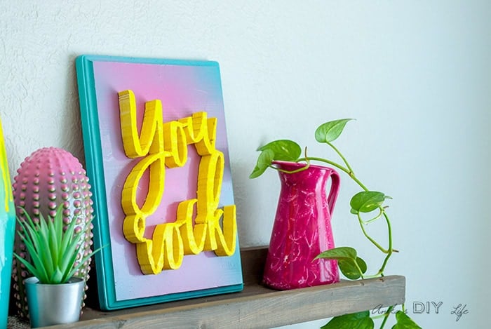 Close up of you rock plaque on colorful shelf