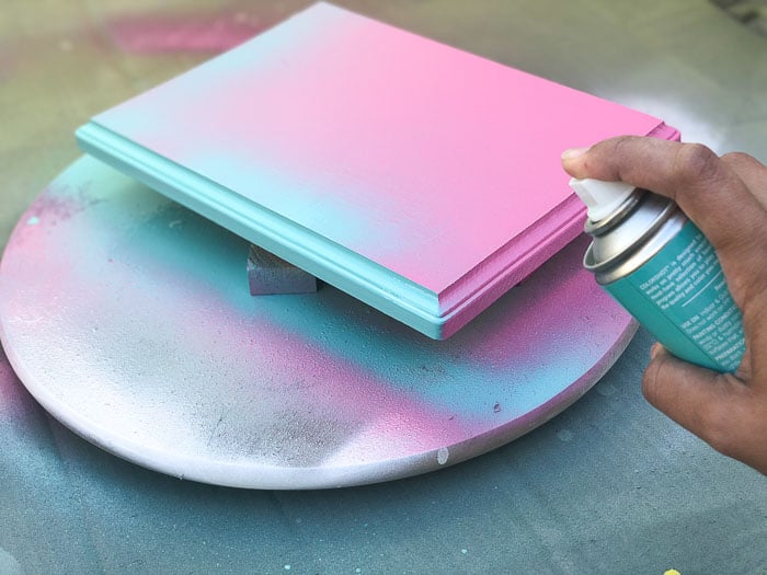 Adding the gradient effect using spray paint to wood plaque.