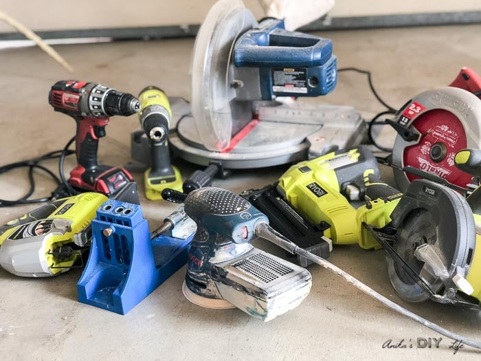 Collection of essential woodworking tools for beginners on workshop floor