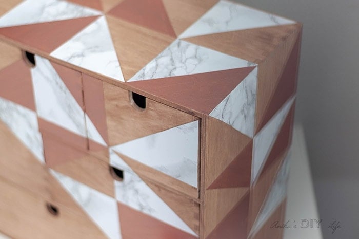 Close up of Ikea Moppe with geometric marble and rose gold triangles