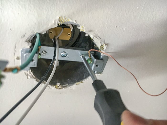 Attaching a light fixture to convert a recessed light to a pendant light