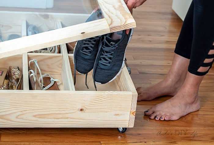 putting shoes in . DIY under bed shoe organizer