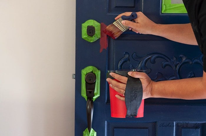 Painting the door with red paint