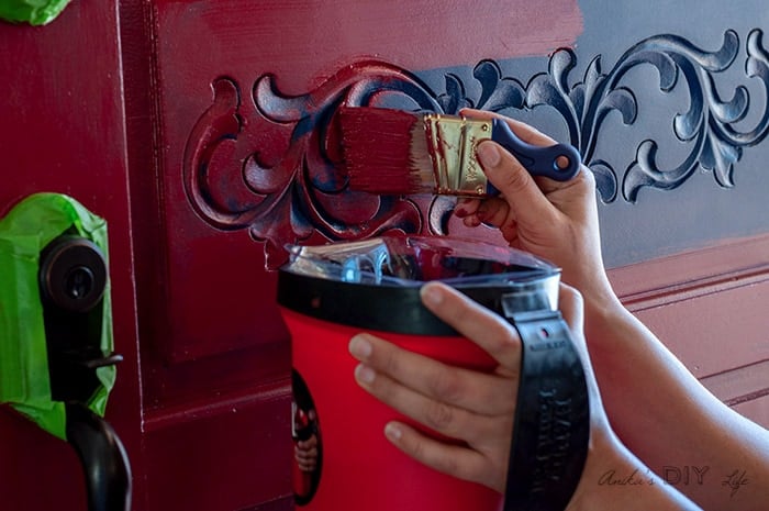 Painting details of the front door for a full makeover.