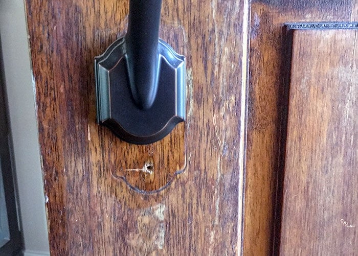 old hardware on old door before front door makeover