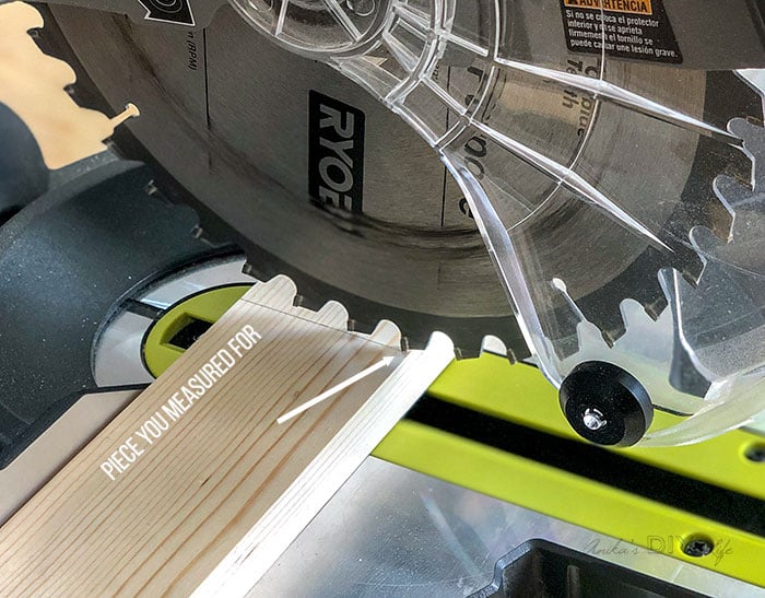 Close up blade checking for kerf to make accurate cuts using a miter saw
