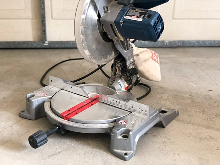 miter saw on garage floor