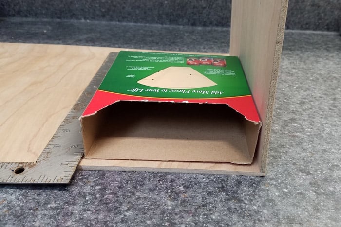 Coffee filter holder on plywood with metal ruler.