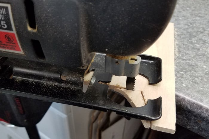 Jigsaw cutting into plywood .