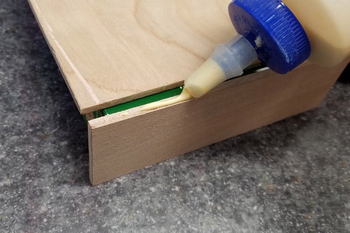 Wood glue being added to plywood edge.
