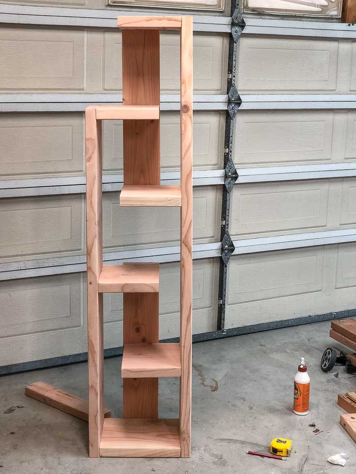 Complete DIY modern bookshelf before staining in a garage