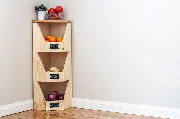 DIY corner vegetable bin with fruits and vegetables.